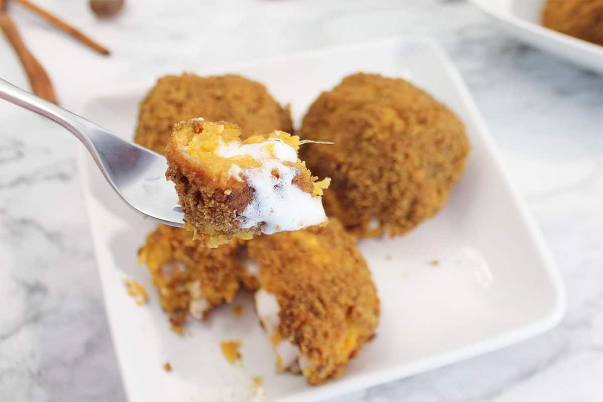 Bite of baked sweet potato ball on fork.