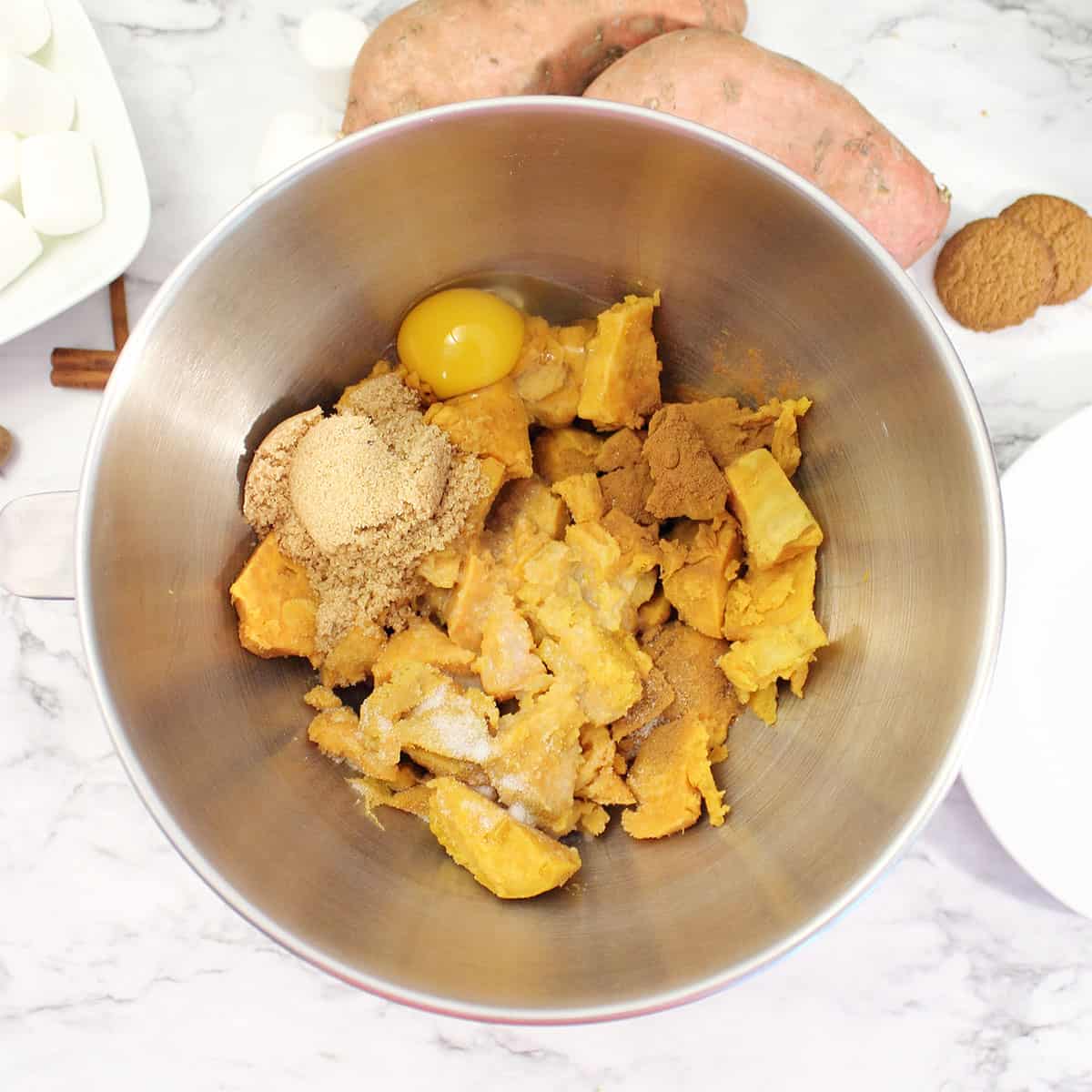 Making mashed sweet potatoes in stainless bowl.