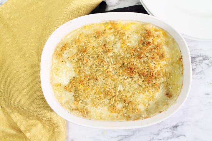 Baked butternut mac and cheese in white casserole dish.