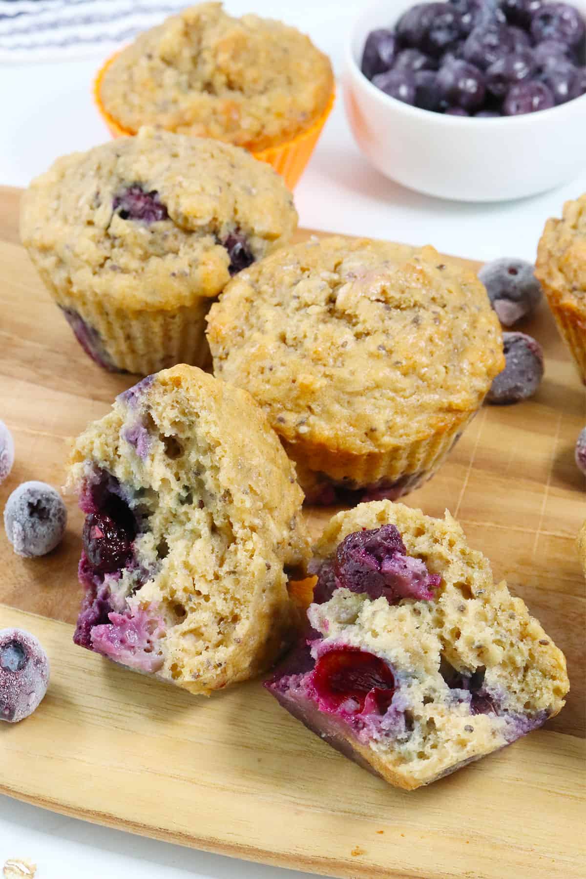Baked Blueberry Oatmeal Muffins with one halved in front.