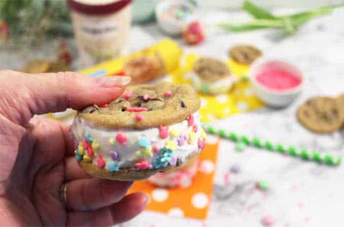Decorate ice cream sandwich with sprinkles
