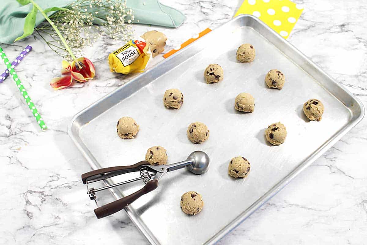 Scooped cookie dough on cookie sheet.