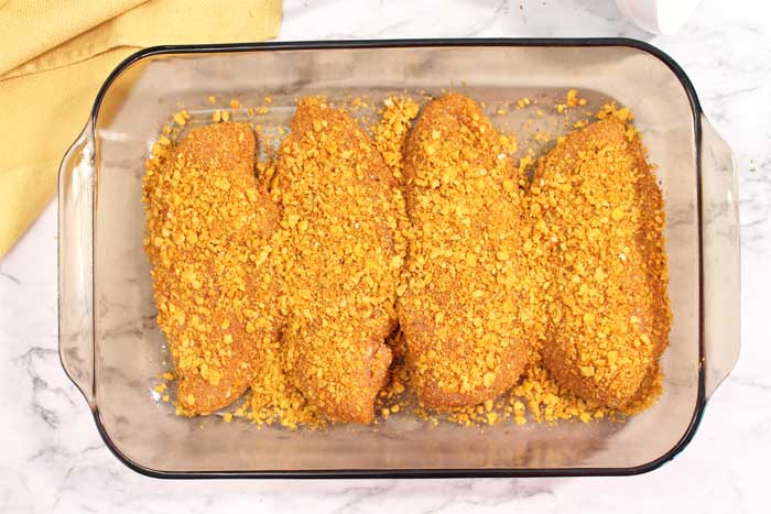 coated chicken in casserole dish