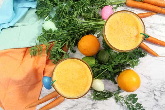 overhead of 2 margaritas surrounded by carrots