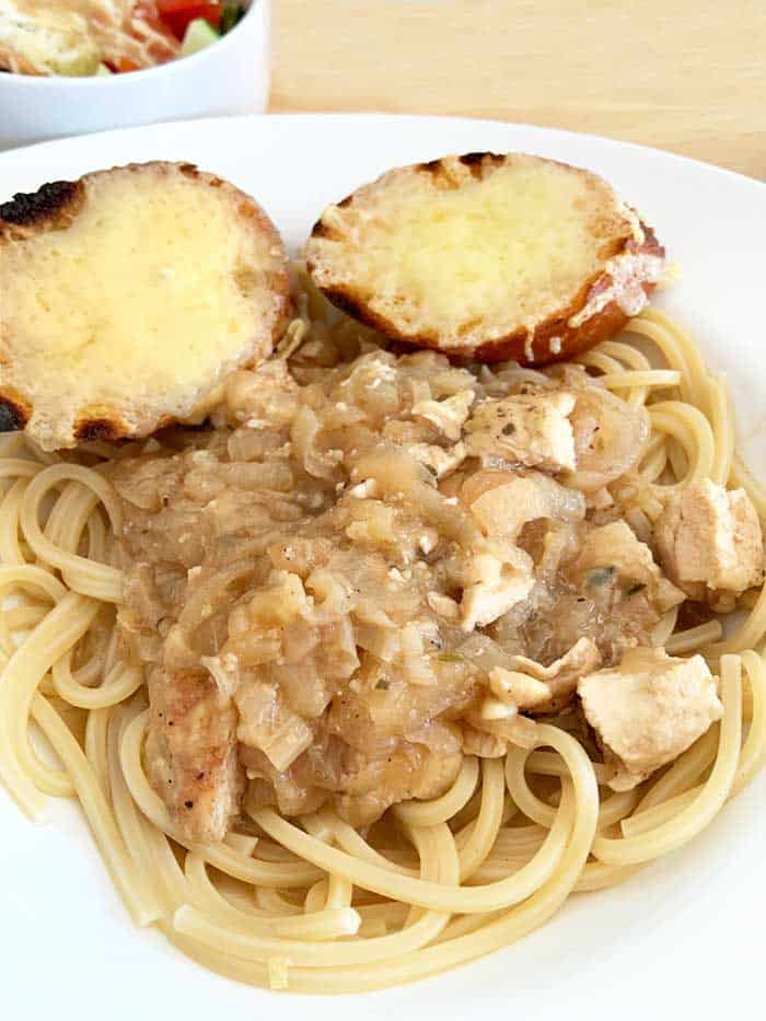 Plated French Onion Chicken on pasta.