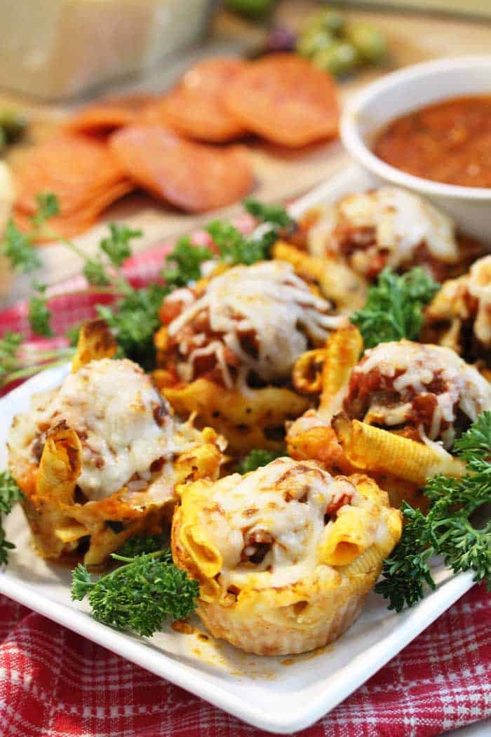 closeup on Spaghetti and Meatball Muffins with blurred sauce in background.