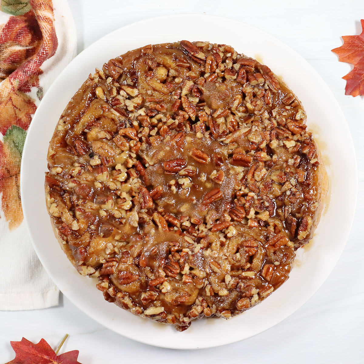 Plated sticky buns with caramel pecan topping.
