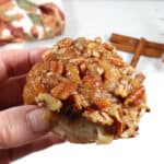 Holding sticky bun showing caramel topping.