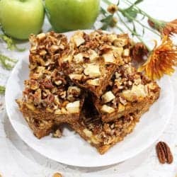 Magic Bars on white plate with apples square.