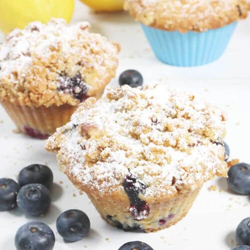 Closeup of lemon blueberry muffins with streusel and powdered sugar.