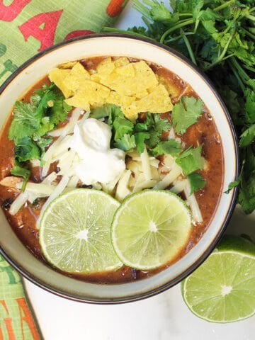 Overhead garnished spicy black bean soup.