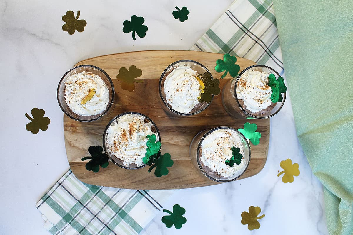 Overhead of pudding with whipped topping and shamrocks.