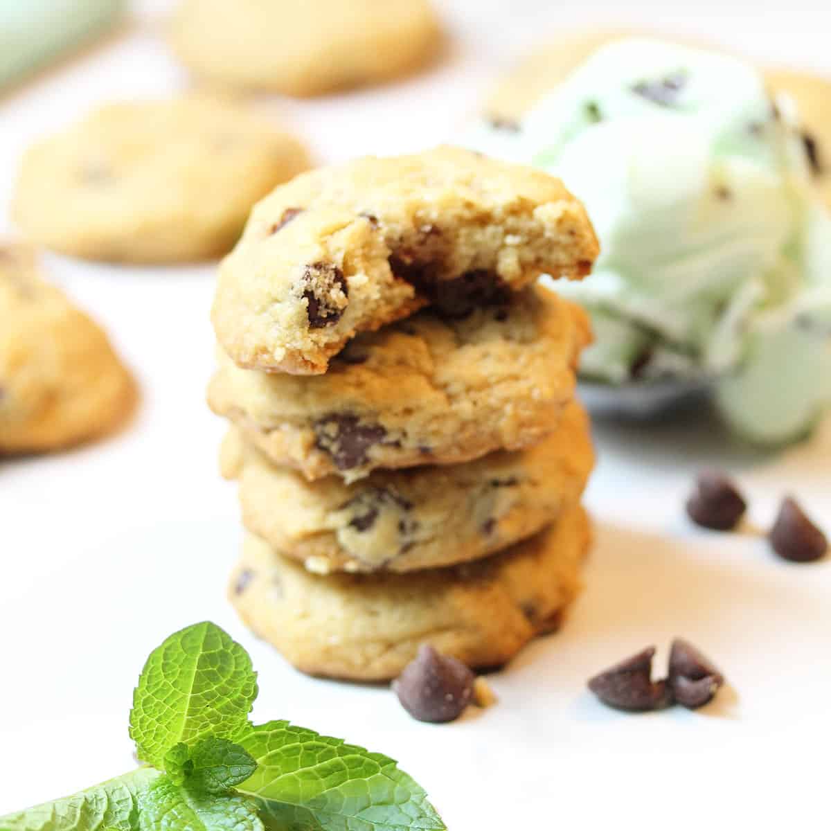 Stack of cookies with bite taken from top cookie with ice cream scoop.