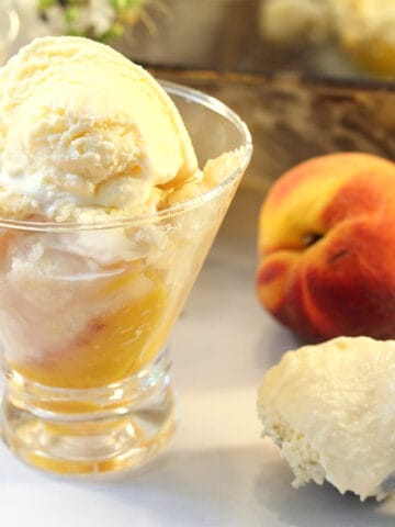 Easy Peach Cobbler in serving dish with scoop of ice cream.