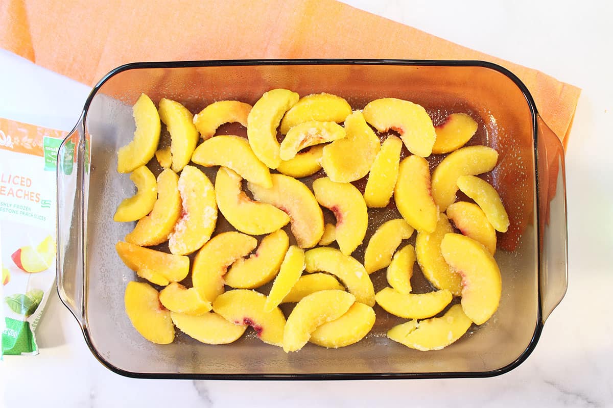 Step 1 Placing peaches in bottom of baking dish.