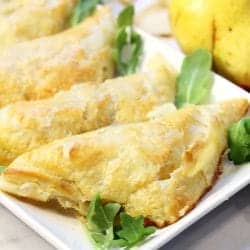 Closeup of puff pastry pocket on platter with arugula.