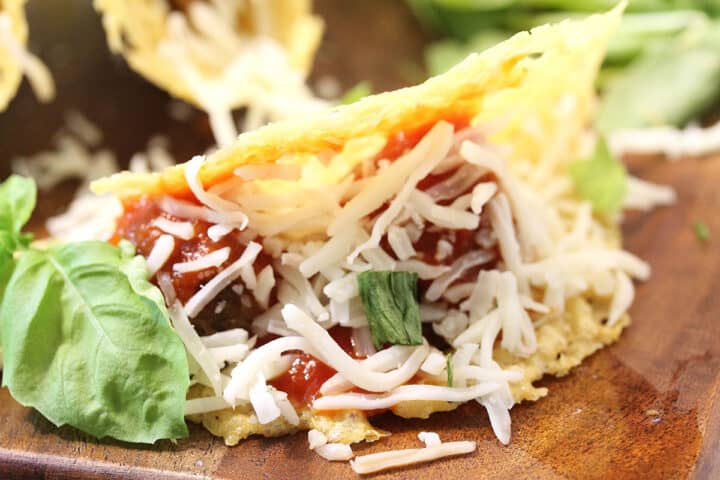 Closeup of inside of taco lying on its side on wooden board.