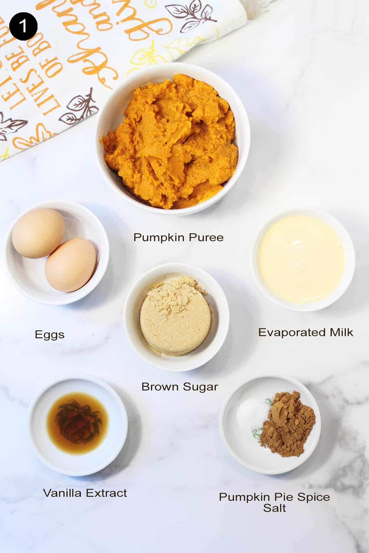 Ingredients for pumpkin filling on white table.