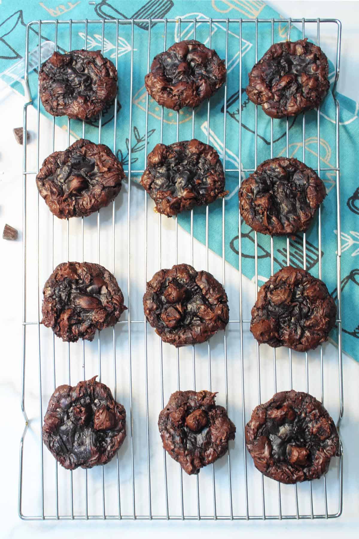 Overhead of flourless caramel chocolate cookies cooling on wire rack.