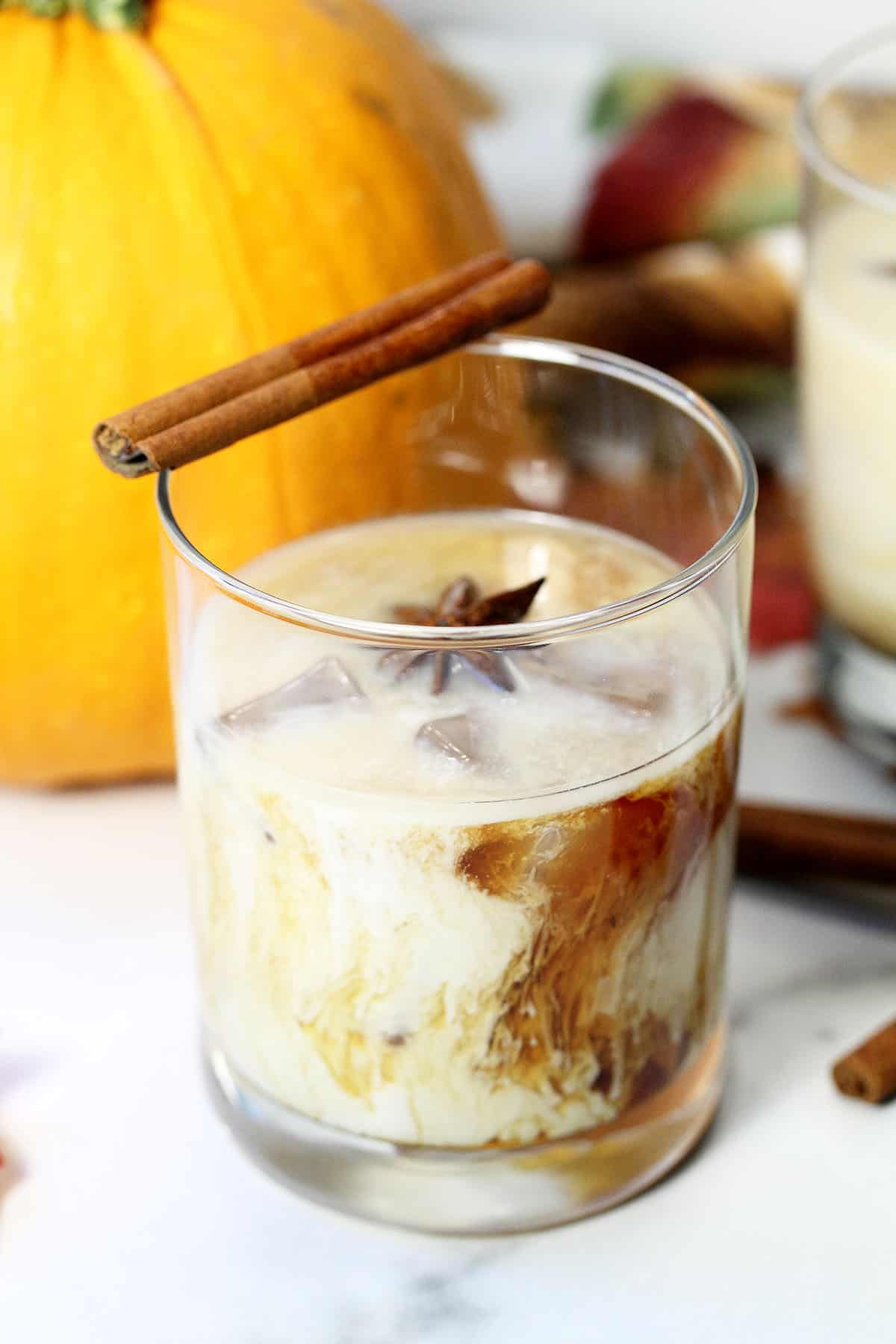 Finished Pumpkin Spice White Russian with a cinnamon stick and anise star garnish.