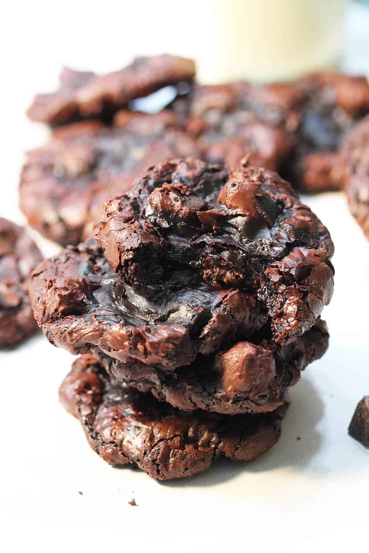 Stack of flourless caramel chocolate cookies with bite taken out of top one.