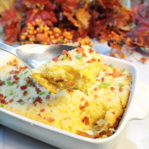 Spoonful of creamy, cheesy corn pudding over casserole.
