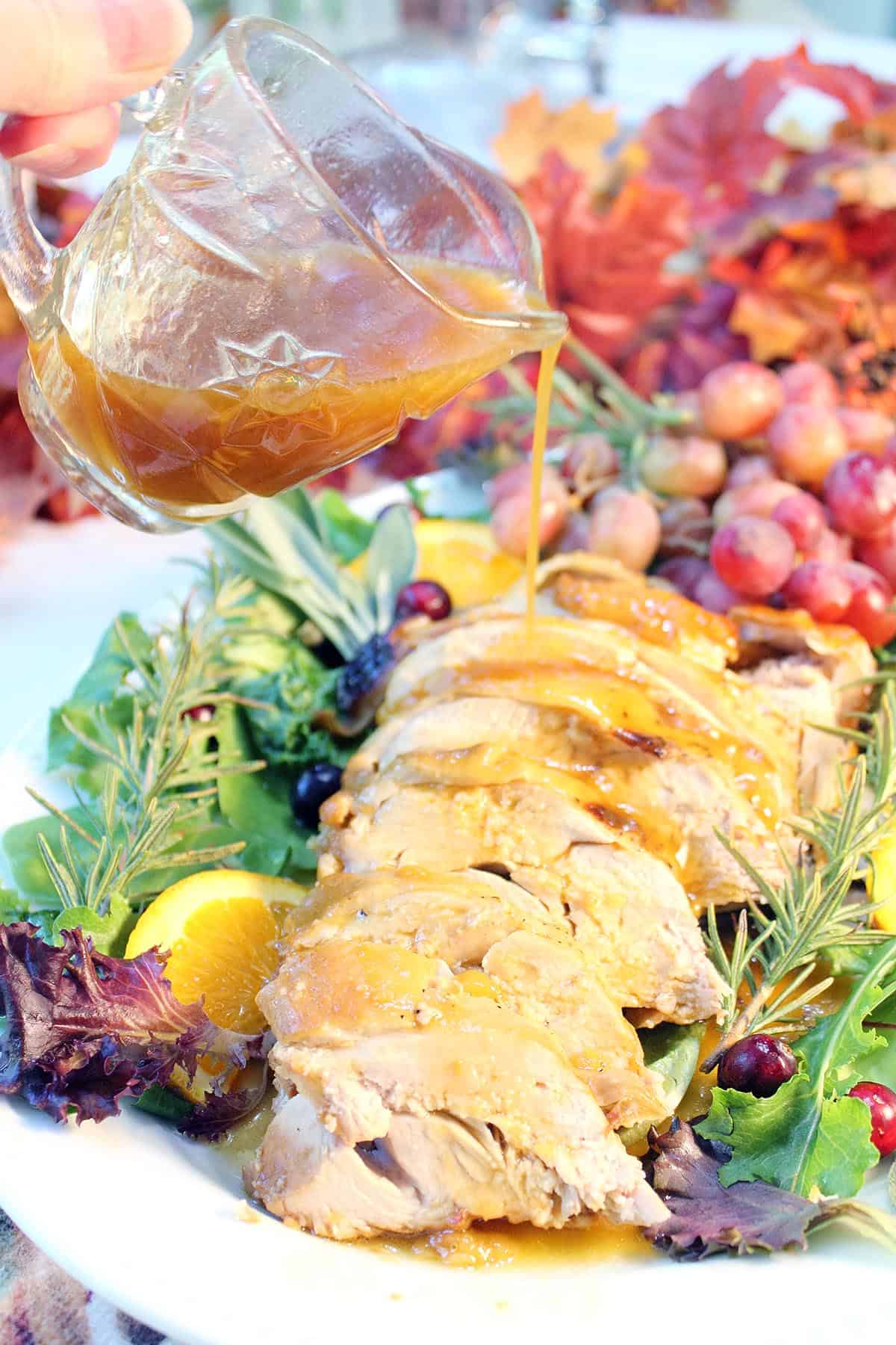 Pouring honey sauce over sliced turkey breast.