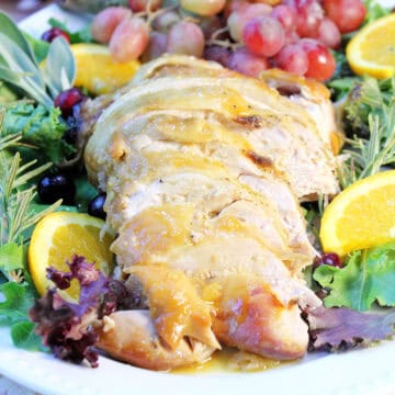 Sliced Baked Turkey Breast with honey gravy on platter.