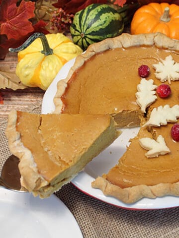 Lifting slice of Pumpkin Pie form pie plate.
