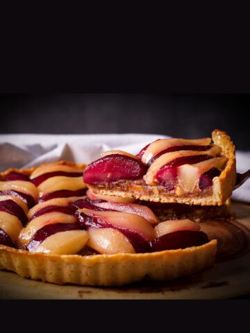 Lifting slice of Pear Tart from pie.