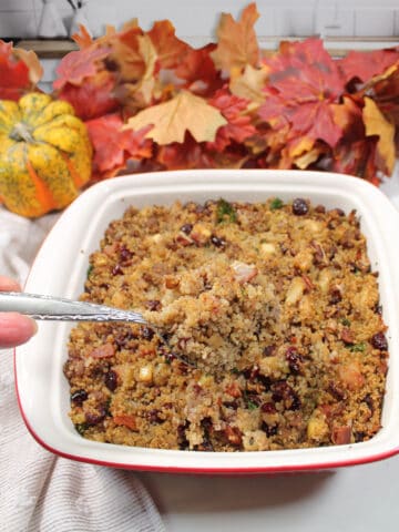 Spoonful of quinoa stuffing over casserole.