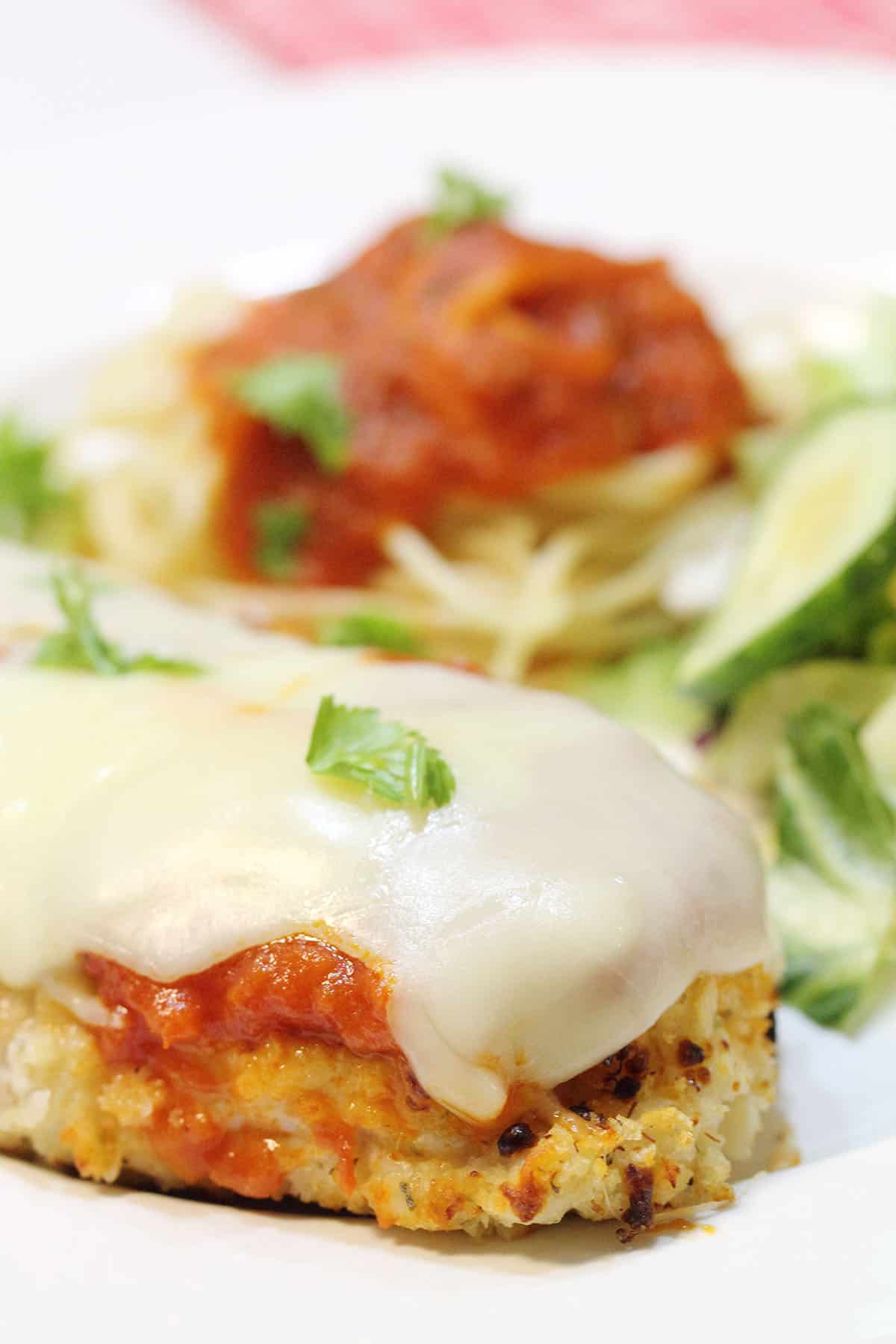 Closeup of plated chicken parmesan dinner.