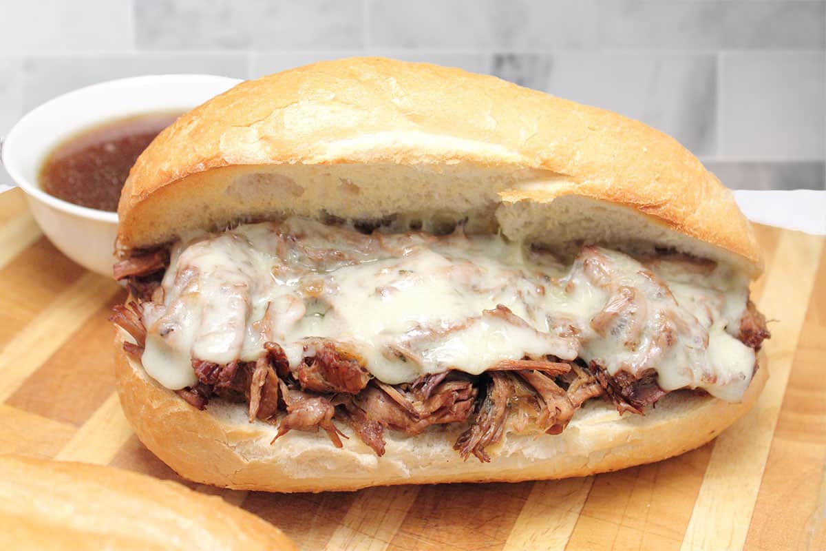Finished crock pot French Dip Sandwich showing melty cheese.