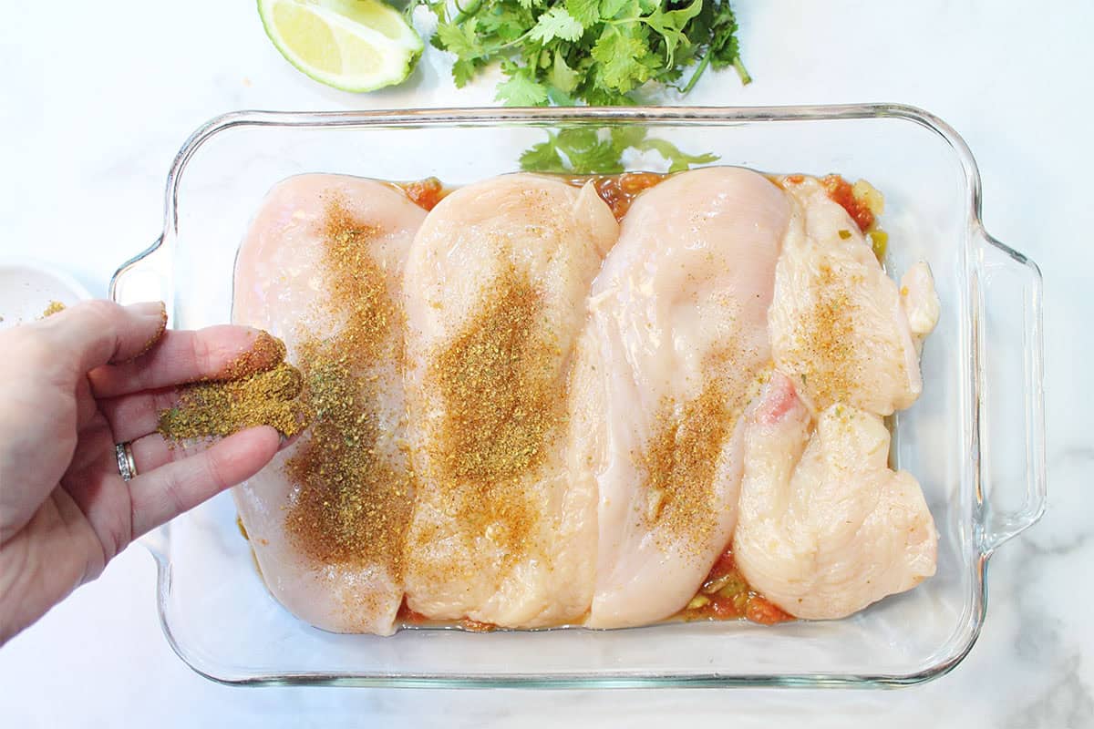 Prep step 1 - chicken in baking dish, sprinkling on taco seasoning.
