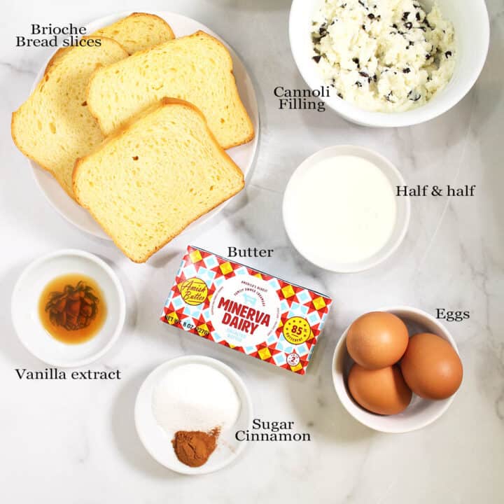 French toast ingredients laid out on marble table.