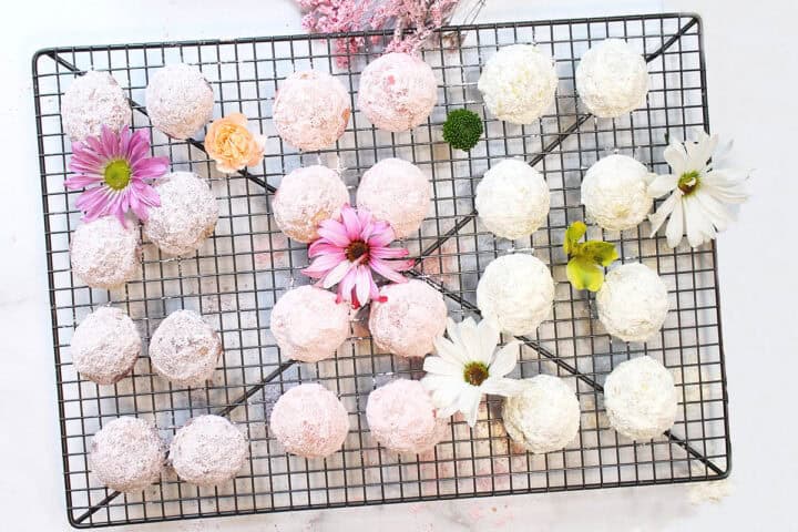 Overhead of pastel sugar dusted cookies on wire rack.
