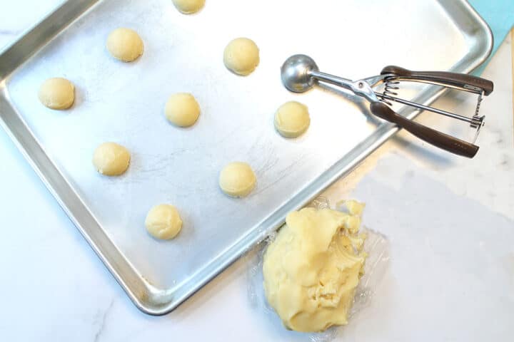 Scooping dough onto cookie sheet.