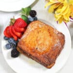 Air fryer French Toast plated with berries.
