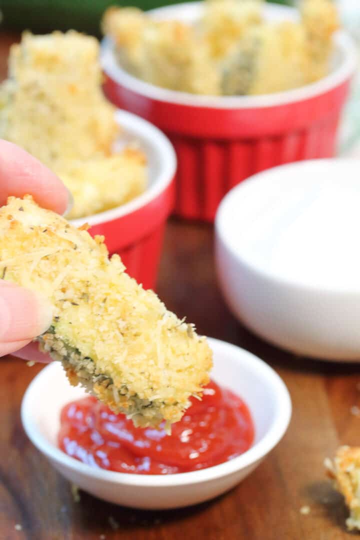 Dipping air fried zucchini into ketchup.