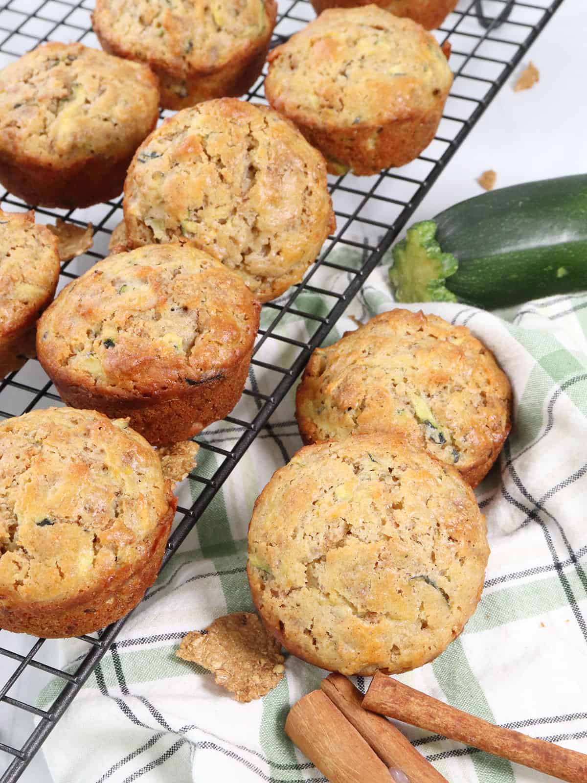Muffins on wire rack with 2 beside it.