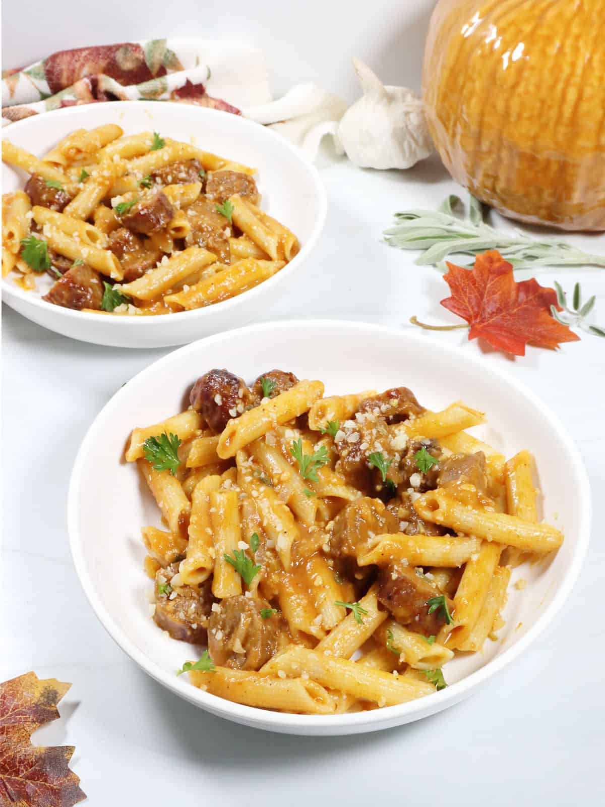 Two servings of Creamy Sausage Pasta with pumpkin sauce.