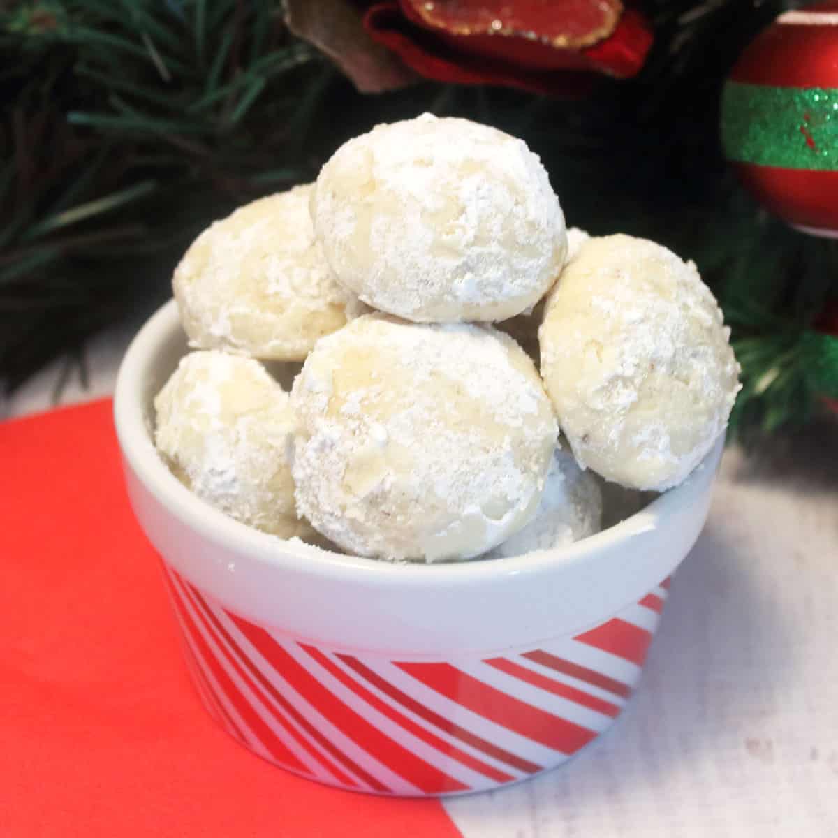 Brazil Nut Snowball Cookies in red and white striped bowl.