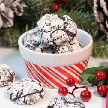 Stacked Double Chocolate Crinkle Cookies with bite out of top cookie.