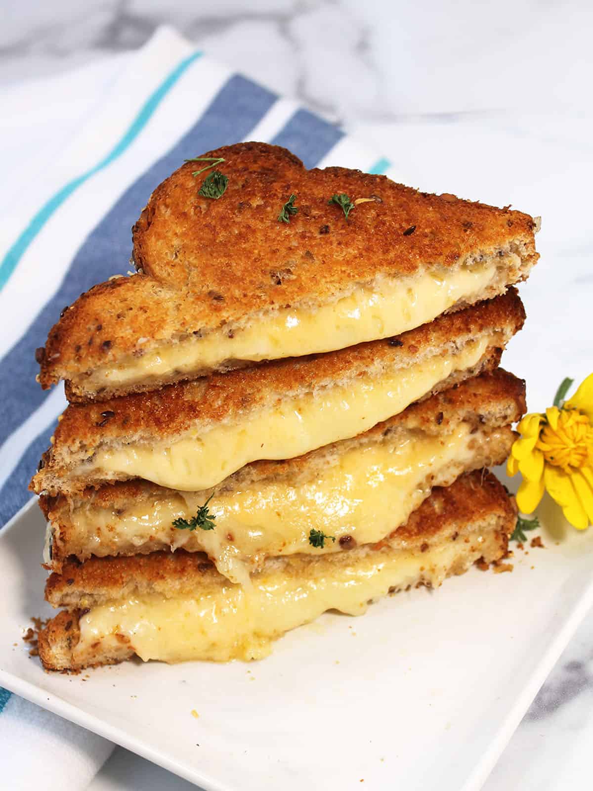 Stacked air fryer grilled cheese showing warm, melty cheese.
