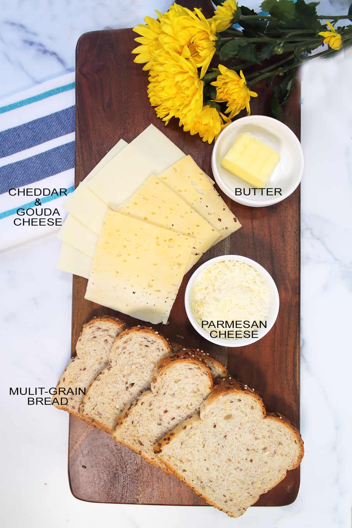 Labeled ingredients for grilled cheese in the air fryer on wooden board.