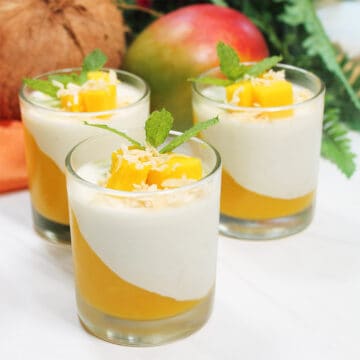 Front view of three garnished coconut milk panna cotta showing design.
