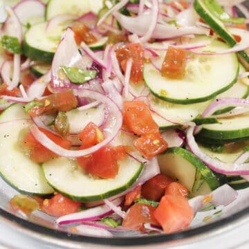 Closeup of cucumber tomato onion salad.