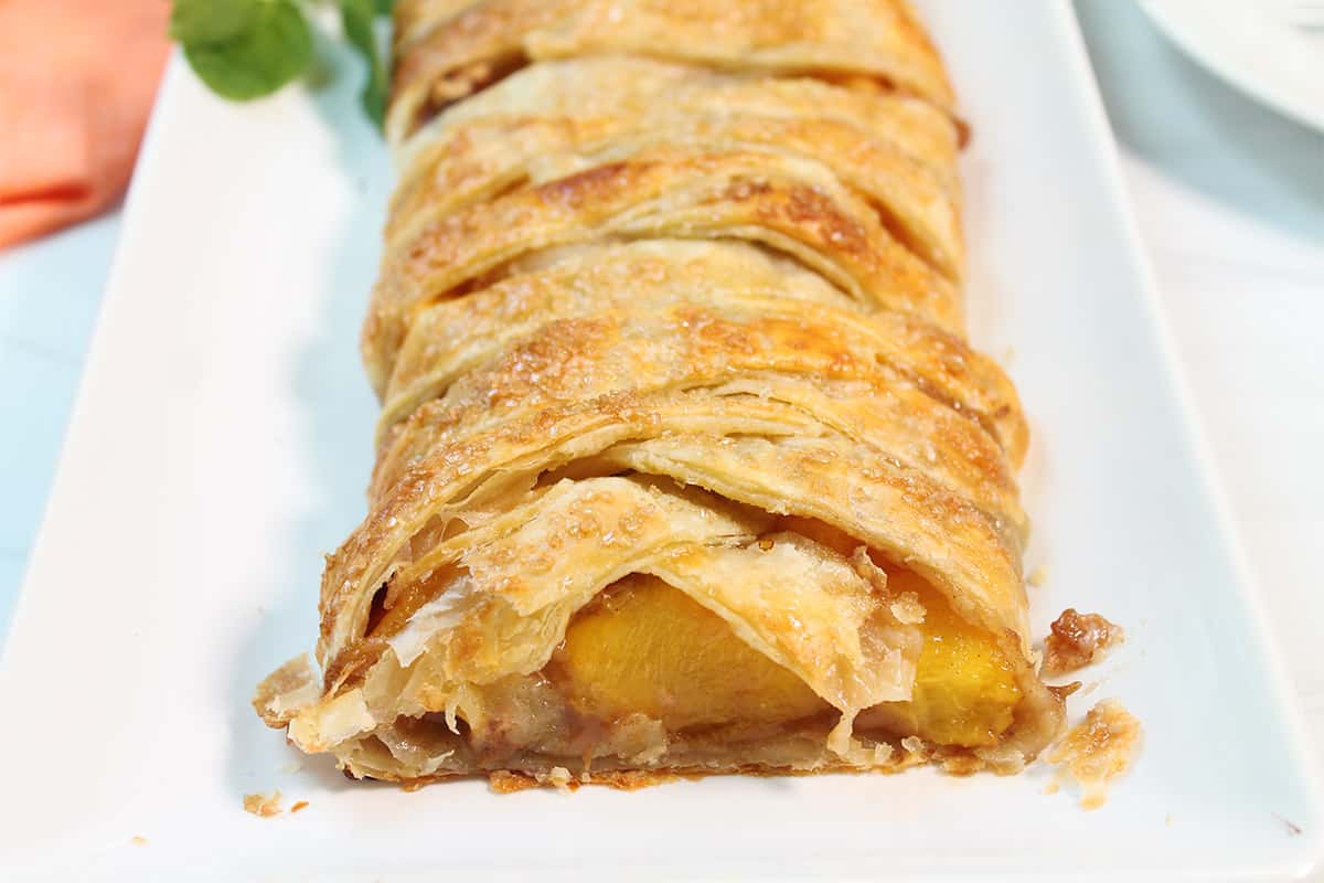 Showing inside of freshly baked puff pastry with peaches.