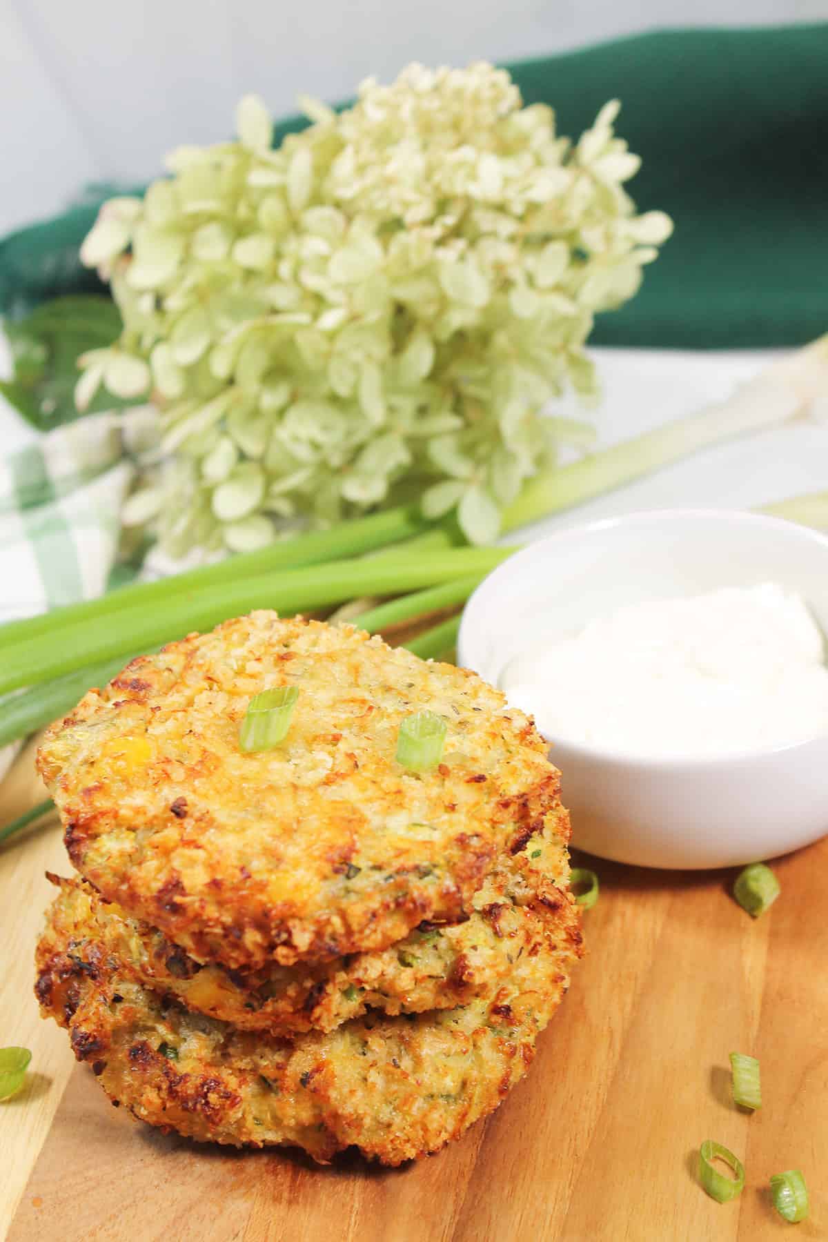 Stacked fritters with sour cream.