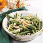 Bowl of air fried green beans with green napkin.